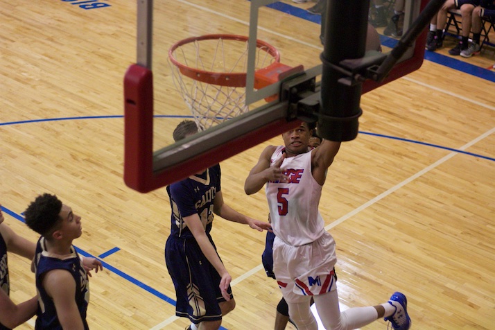 Bishop MIege's Ezekiel Lopes lays in two of his 10 points in the first half. He scored the first seven of the fourth quarter to help Miege climb back into the game after being down as many as 11.