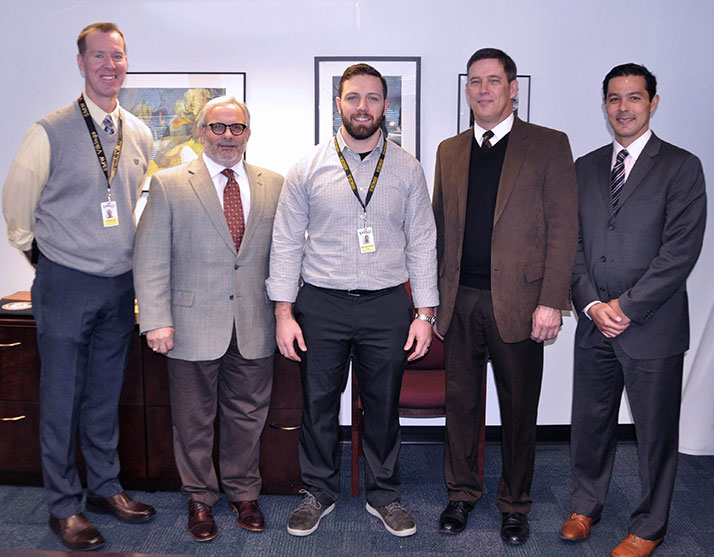 From left, Steve Loe, SM West principal; Dr. Kenny Southwick, deputy superintendent; Matthew Baker, SM West science teacher; Dr. Jim Hinson superintendent; and Dr. Michael Schumacher, assistant director for human resources.