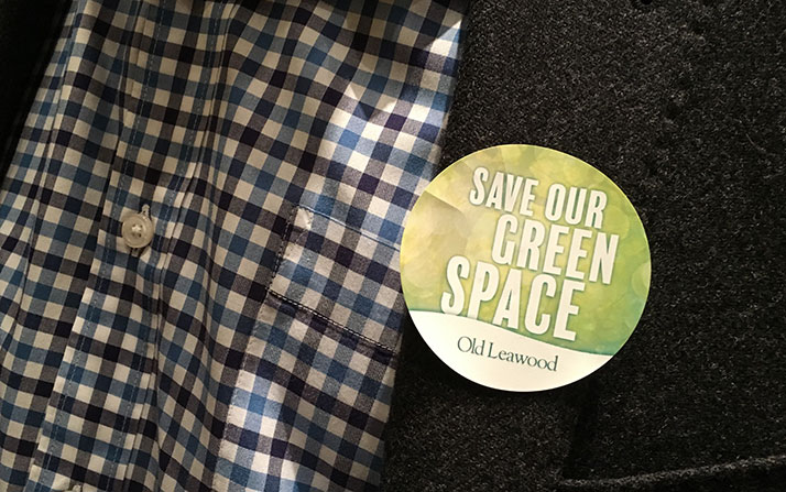 North Leawood homeowners wore stickers showing their opposition to a request to rezone part of the old Leawood Country Club property on Tuesday.