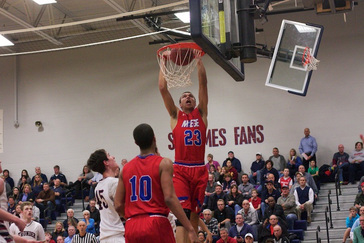 Bishop Miege senior Francesco Badocchi finishes a slam for two of his 18 points in the Stags' six-point win on Tuesday night.