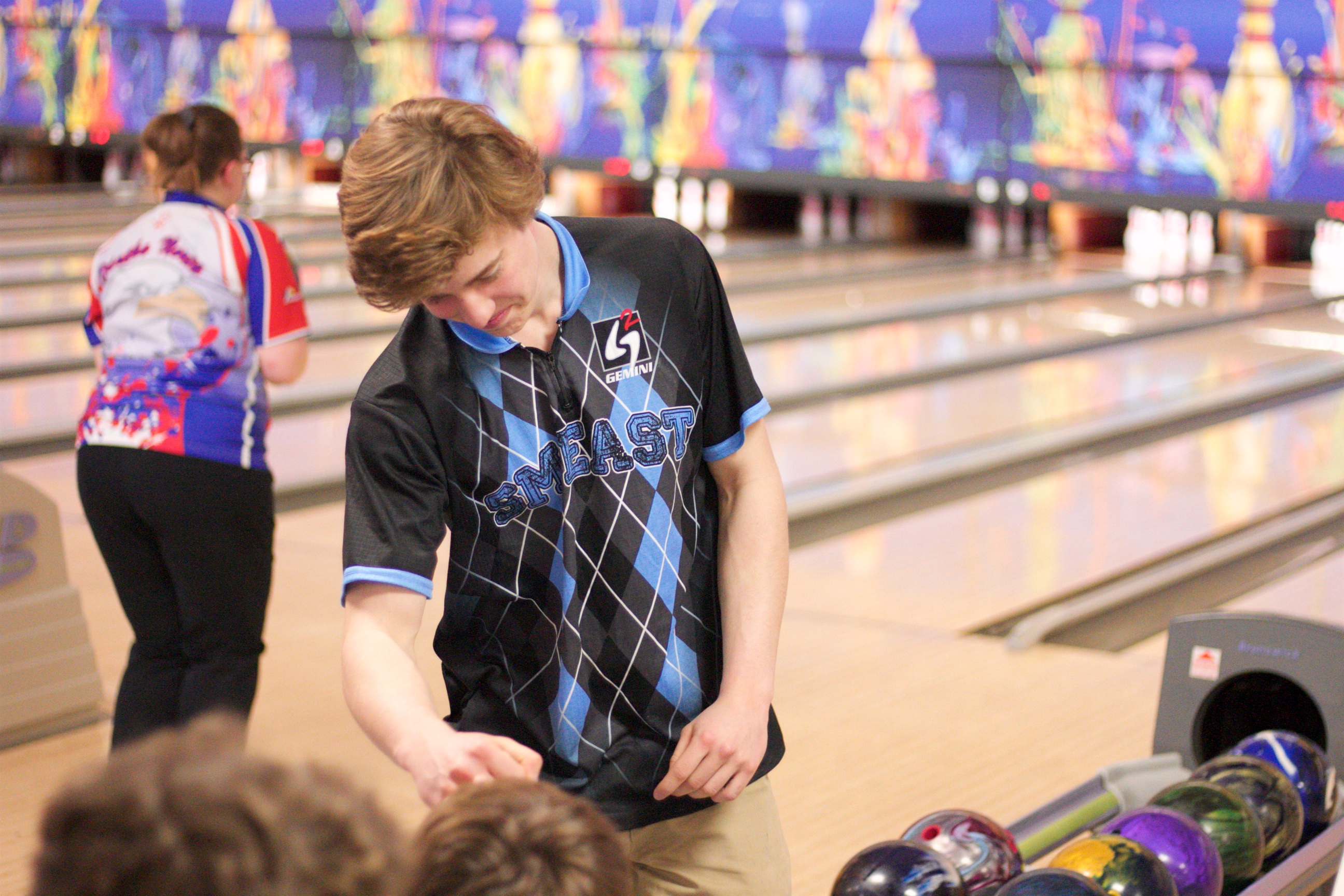 Shawnee Mission's Ian Estes receives a fist bump from Chase Tetrick after Estes rolled a strike.