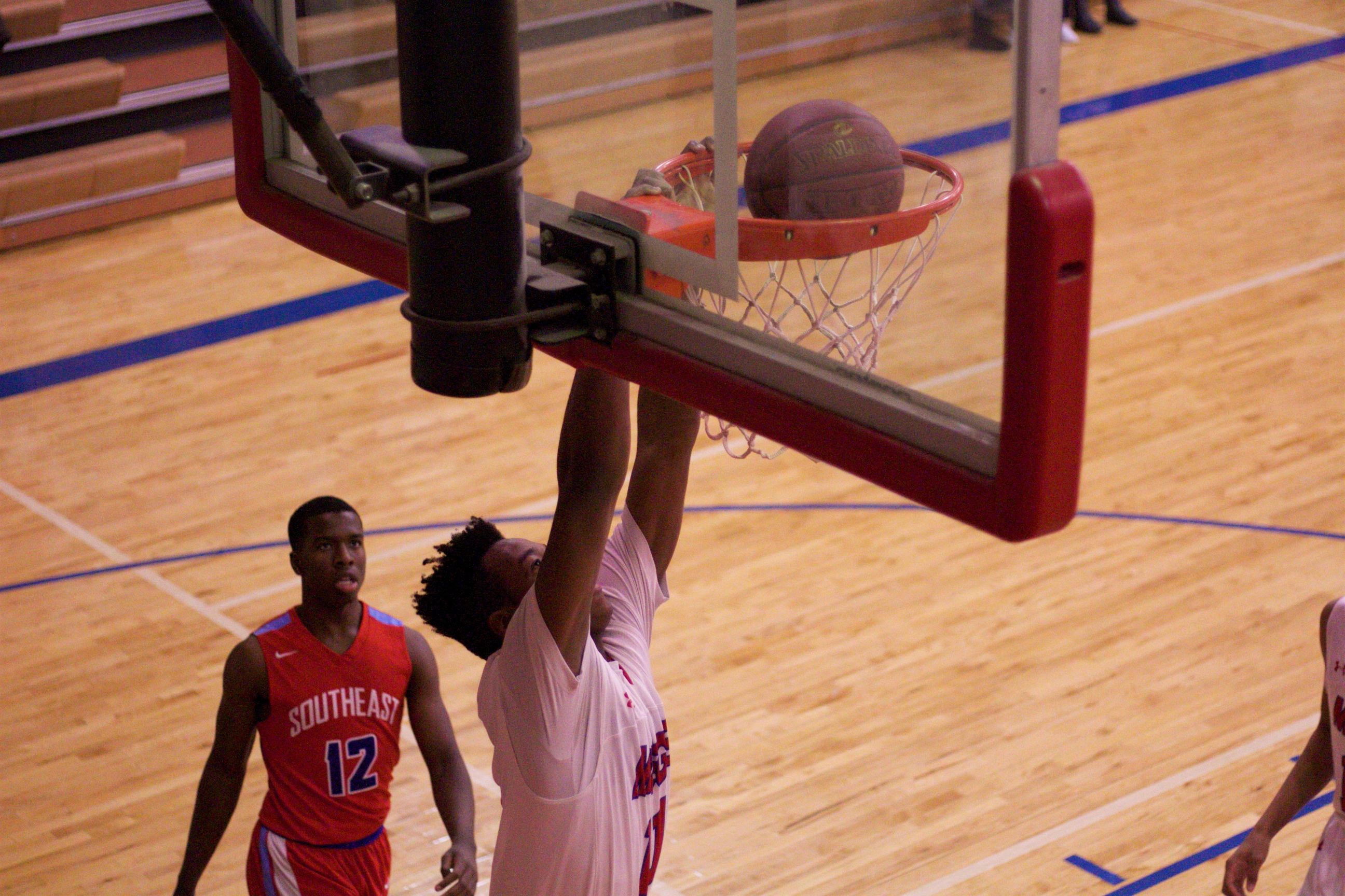 Bishop Miege sophomore Josh Earley dunks home two of his eight points in the Stags' 29-point victory.
