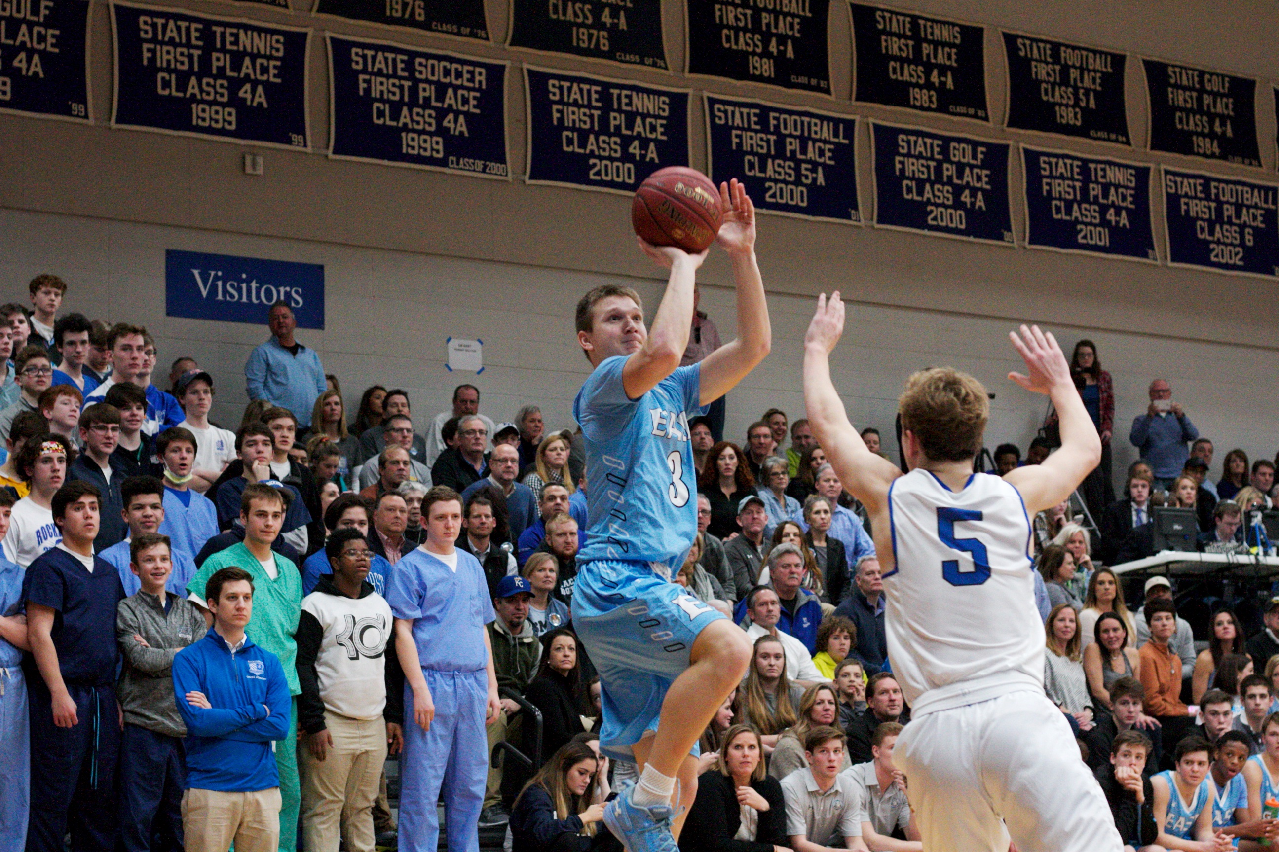 SM East's Trevor Thompson hits a fadeaway jumper over Rockhurst's Ross Elder. Thompson led all scorers with 17 points.
