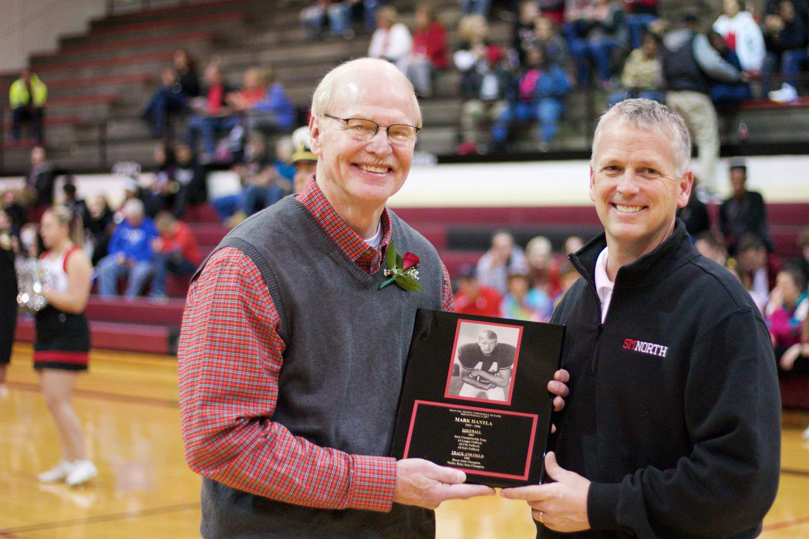 SM North hall of fame inductee Mark Hantla, left, is presented his plaque by athletic director Ken Glaser.