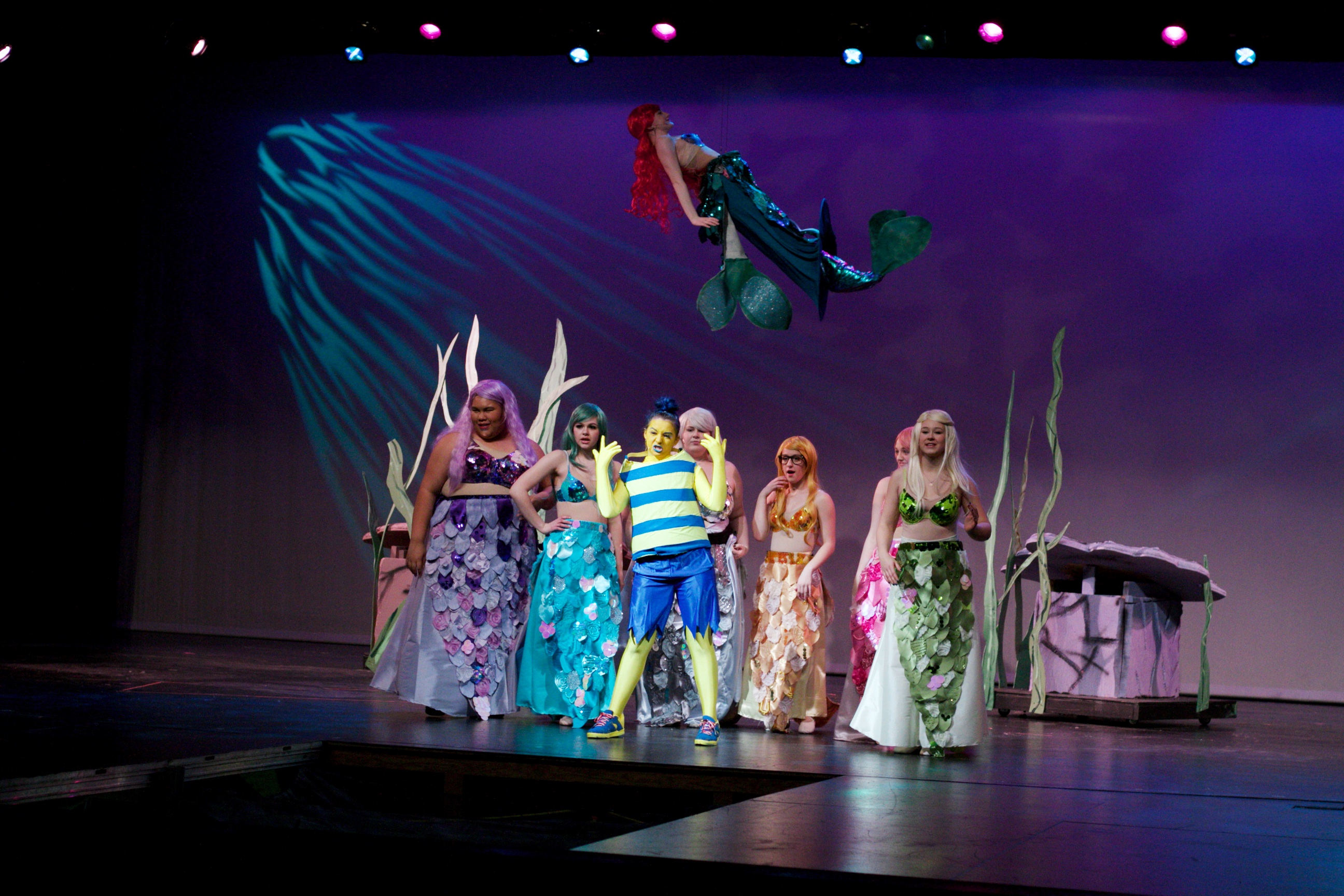 SM South senior Megan Berning swims through the air during a musical ensemble during dress rehearsal.