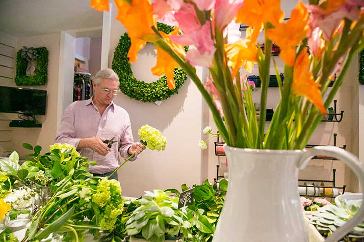 Chuck Matney at work arranging flowers at The Little Flower Shop.