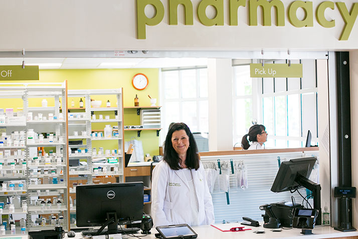 Debbie Richmond behind the counter of the new Hen House pharmacy location at the Village Shops.