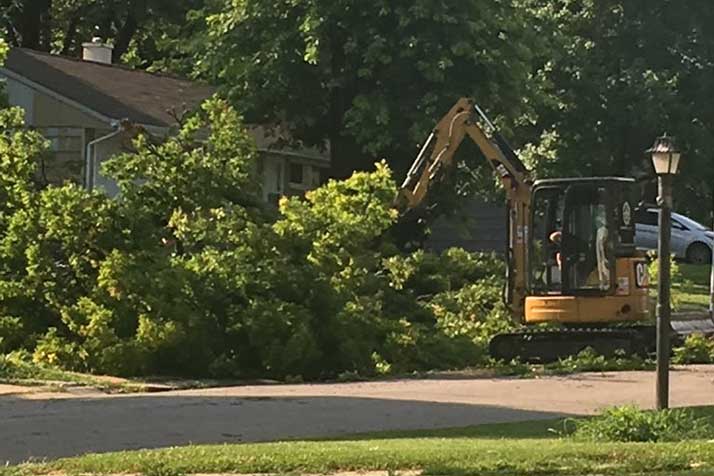City crews worked to clear the streets of fallen limbs in northern Overland Park Sunday.
