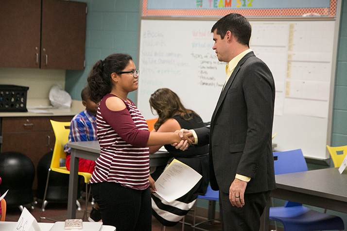 ApacheIS principal Britt Pumphery shakes the hand of a job applicant.