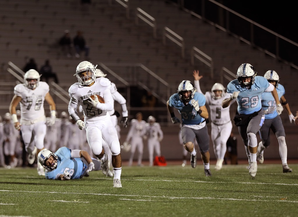 Running back Anthony Bragulla, Jr., sprints away from the SM East defense. Photo by Andrew Poland.