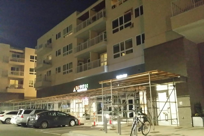 Construction crews set up scaffolding at Woodside Village in October as they began to make repairs to the building's poorly constructed exterior.
