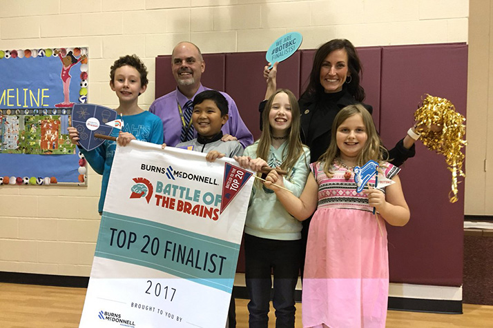 Merriam Park instructional coach Dustin Springer and principal Cho Druen celebrate with students after learning they were finalists in this year's Battle of the Brains competition. Photo via Merriam Park Elementary on Twitter.