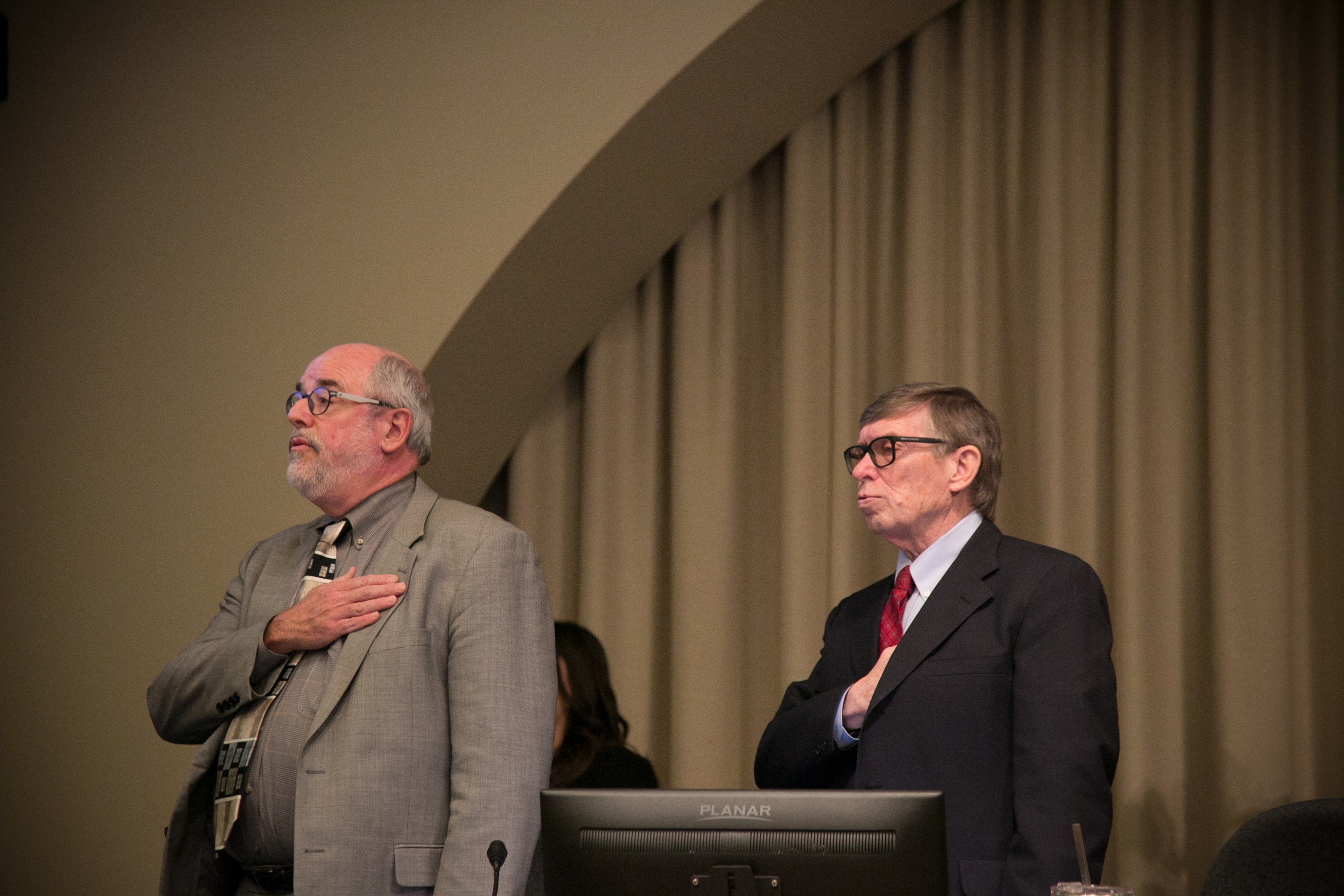 Hannes Zacharias, left, says the pledge of allegiance ahead of a Board of County Commissioners meeting.