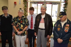 Pearl Harbor survivors Jess Dunnagan, Edmund 'Russ' Russell, Jack Carson, and Dorwin Lamkin with remembrance organizer Quinn Appletoft at the Sylvester Powell Community Center awaiting the start of Pearl Harbor Day remembrance ceremonies.