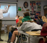 A teacher at the front of the classroom