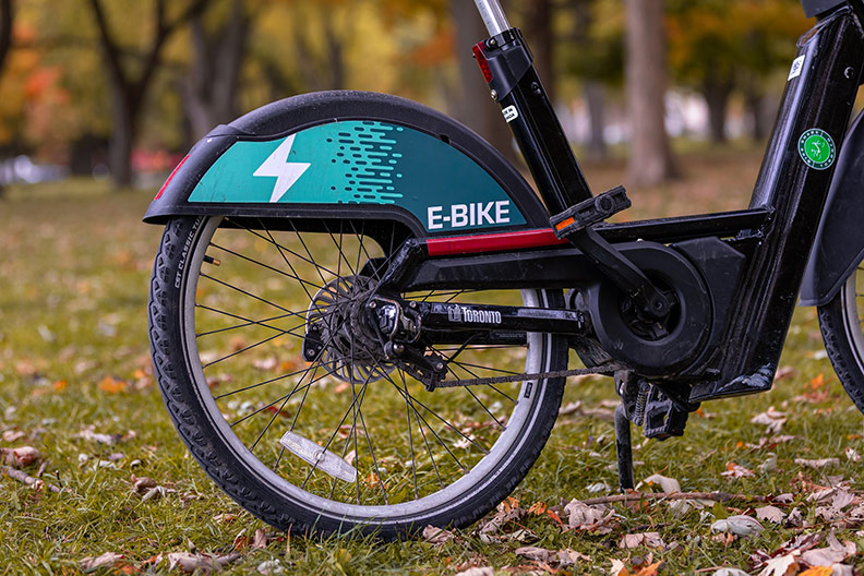 An e-bike stopped in a city park. The devices will be allowed on Overland Park city trails. 